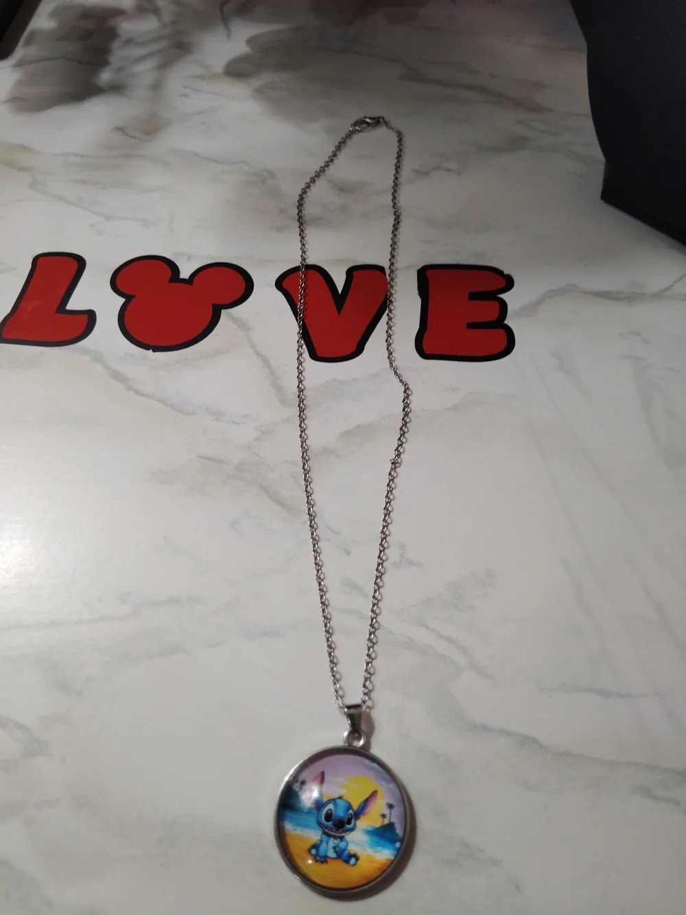 Silver-tone Blue Stitch Pendant Necklace